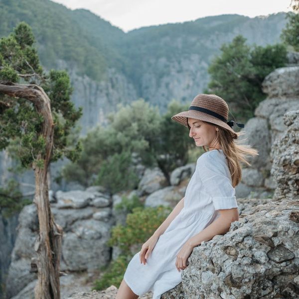 Person meditating peacefully outdoors with soft natural light.